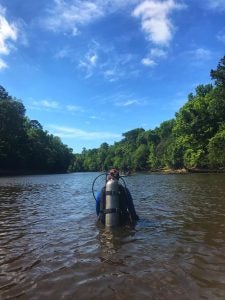 Student wades through Tar River in search of shipwrecks