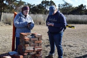 Students document the remains of a historic house on Portsmouth Island, NC.